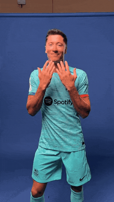A Man Wearing A Shirt That Says Spotify Is Dancing GIF