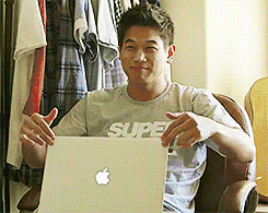 A Man Wearing A Shirt That Says Super Is Holding A Laptop GIF
