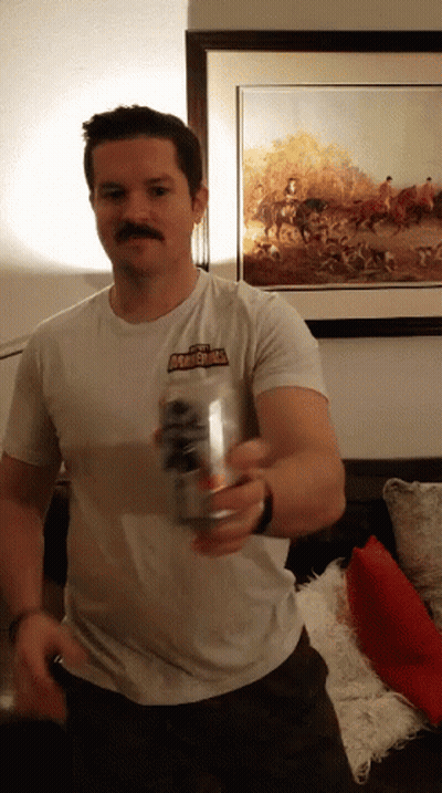 A Man Wearing A Shirt That Says Thunderbolt Holds A Can Of Beer GIF