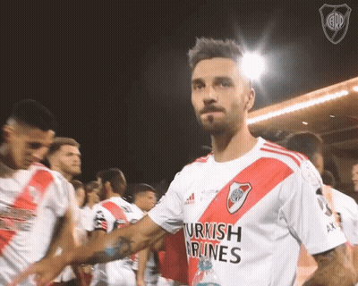 A Man Wearing A Shirt That Says Turkish Airlines Shakes Hands With His Teammates GIF
