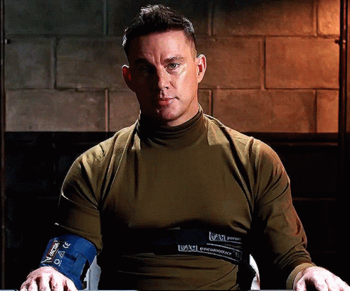 A Man Wearing A Shirt That Says ' U.s. Army ' On The Front GIF