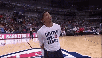 A Man Wearing A Shirt That Says United We Stand GIF