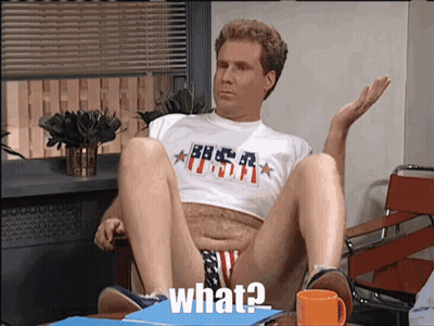 A Man Wearing A Shirt That Says ' What ' On It Sits In A Chair GIF