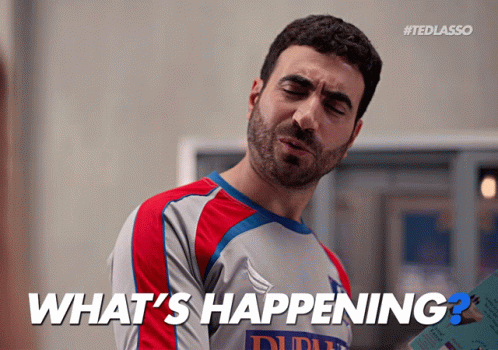 A Man Wearing A Shirt That Says What 'S Happening On It GIF