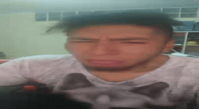A Man Wearing A Shirt With A Cat On It Is Making A Funny Face GIF