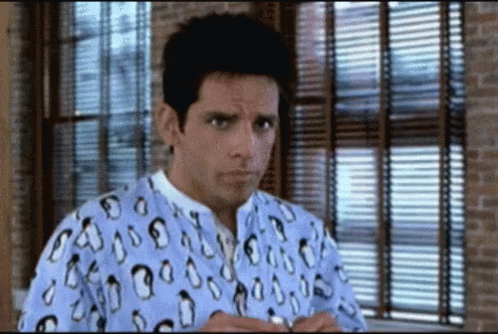 A Man Wearing A Shirt With Penguins On It Stands In Front Of A Window GIF