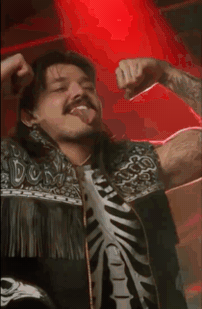 A Man Wearing A Skeleton Shirt Is Dancing In A Dark Room GIF