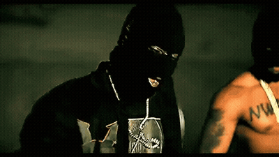 A Man Wearing A Ski Mask And A Shirt With The Letter W On It GIF