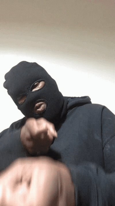 A Man Wearing A Ski Mask Is Pointing His Finger GIF