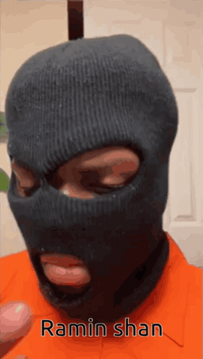 A Man Wearing A Ski Mask With The Name Ramin Shan Written On It GIF