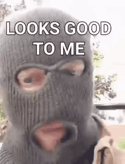 A Man Wearing A Ski Mask With The Words `` Looks Good To Me '' On It . GIF