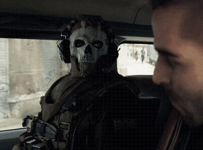 A Man Wearing A Skull Mask Looks At Another Man In A Car GIF