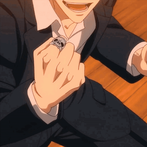 A Man Wearing A Skull Ring On His Finger GIF