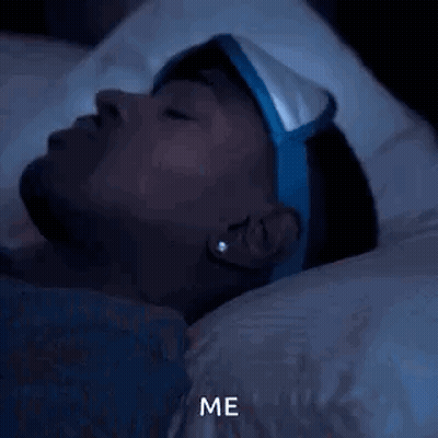 A Man Wearing A Sleep Mask Is Laying In Bed At Night And Says Me . GIF
