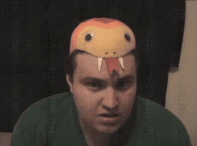 A Man Wearing A Snake Hat Looks Angry GIF