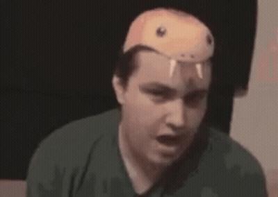 A Man Wearing A Snake Mask On His Head Is Saying I 'M A Snake . GIF