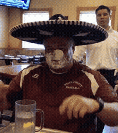 A Man Wearing A Sombrero And A Shirt That Says ' Water County Baseball ' GIF