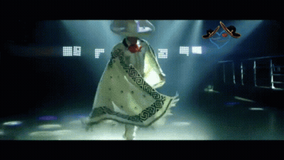 A Man Wearing A Sombrero And A White Cape Is Dancing GIF