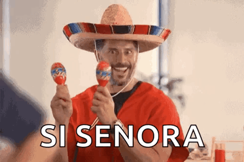 A Man Wearing A Sombrero Is Holding Maracas And Smiling With The Words Si Senora Behind Him GIF