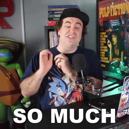 A Man Wearing A Sonic T-Shirt Stands In Front Of A Microphone And Says So Much GIF