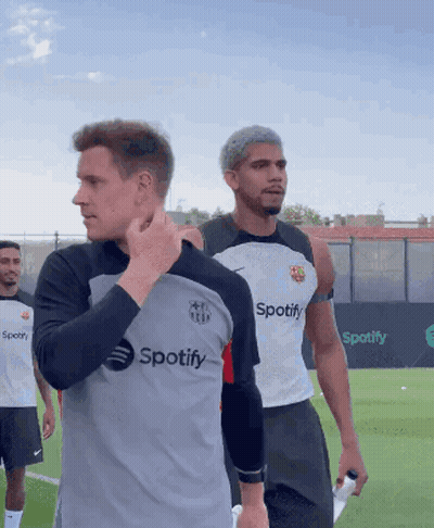 A Man Wearing A Spotify Shirt Stands On A Field GIF