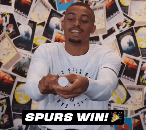 A Man Wearing A Spurs Shirt Is Holding A Bottle In His Hands GIF