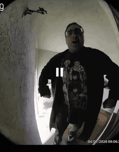 A Man Wearing A Star Wars Shirt Is Standing In A Room GIF