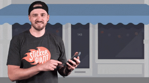 A Man Wearing A Sticker Giant T-Shirt Holds A Cell Phone GIF