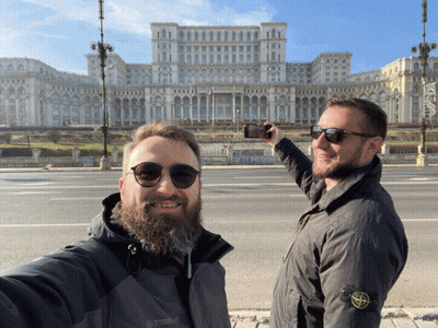 A Man Wearing A Stone Island Jacket Takes A Selfie With Another Man GIF