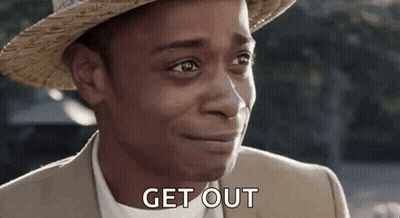 A Man Wearing A Straw Hat And A Suit Is Smiling And Saying `` Get Out '' . GIF
