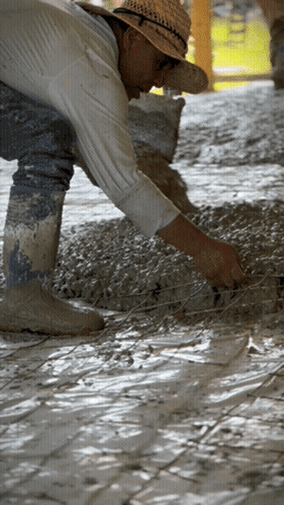 A Man Wearing A Straw Hat Is Working On A Tile Floor GIF