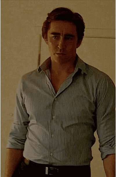 A Man Wearing A Striped Shirt And Black Belt GIF