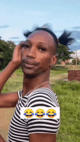 A Man Wearing A Striped Shirt Is Making A Funny Face With Three Smiley Faces . GIF