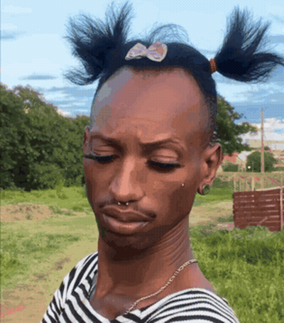 A Man Wearing A Striped Shirt With Pigtails On His Head GIF
