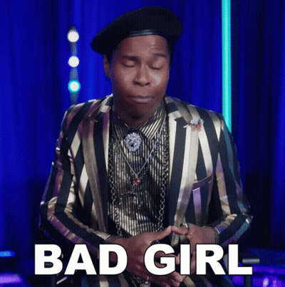 A Man Wearing A Striped Suit And A Black Hat Says Bad Girl GIF