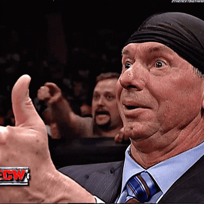 A Man Wearing A Suit And Tie Is Giving A Thumbs Up GIF