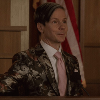 A Man Wearing A Suit And Tie Is Giving A Thumbs Up GIF