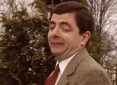 A Man Wearing A Suit And Tie Is Making A Funny Face GIF