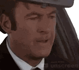 A Man Wearing A Suit And Tie Is Smiling With His Eyes Closed And Made With Sunscreen Sticker