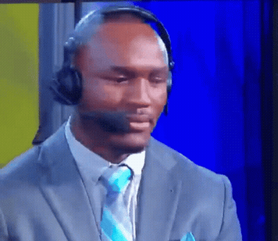 A Man Wearing A Suit And Tie Is Wearing A Headset GIF
