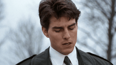 A Man Wearing A Suit And Tie Looks Down With His Eyes Closed GIF