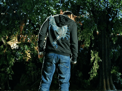 A Man Wearing A Superman T-Shirt And A Black Hoodie GIF