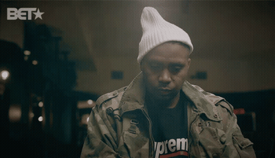 A Man Wearing A Supreme T-Shirt And A White Beanie GIF