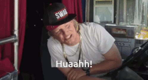 A Man Wearing A Swag Hat And A White Shirt Says Huaahh GIF