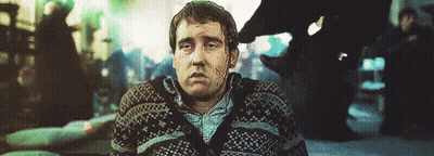 A Man Wearing A Sweater Is Sitting On The Floor With His Eyes Closed . GIF