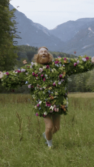 A Man Wearing A Sweater Made Of Flowers And Leaves GIF