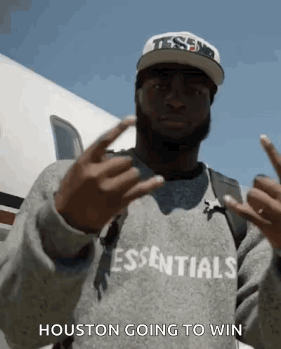 A Man Wearing A Sweatshirt That Says Essentials On It GIF