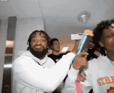 A Man Wearing A Sweatshirt That Says ' Std ' On The Front GIF
