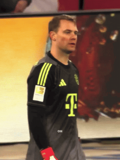 A Man Wearing A T-Mobile Jersey Stands In Front Of A Screen GIF