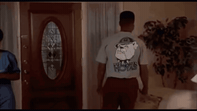 A Man Wearing A T-Shirt That Says Boys On The Back GIF